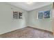 Bright bedroom with neutral paint, cozy carpeting, and double-paned windows at 8259 Nola Dr, Denver, CO 80221