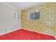 Cozy bedroom featuring colorful floral wallpaper and bright red carpet at 8259 Nola Dr, Denver, CO 80221