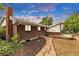 Brick home featuring stone pathway, manicured garden beds, and a cozy sunroom, enhancing curb appeal at 8259 Nola Dr, Denver, CO 80221
