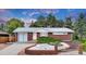 Charming brick home with landscaped yard, garage and inviting front entrance at 8259 Nola Dr, Denver, CO 80221