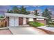 Charming brick home featuring a well-maintained front yard, attached garage and inviting entrance at 8259 Nola Dr, Denver, CO 80221