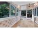 Bright sun room with hardwood floors and large windows offering natural light and views at 8259 Nola Dr, Denver, CO 80221