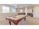 Finished basement with a pool table and a comfortable seating area featuring leather couches and good lighting at 3925 W 149Th Ave, Broomfield, CO 80023