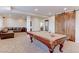 Spacious finished basement with a pool table, a leather sectional couch, a bar, and stylish barn doors at 3925 W 149Th Ave, Broomfield, CO 80023