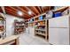 Organized basement storage area with shelving, refrigerator, and ample space at 3925 W 149Th Ave, Broomfield, CO 80023