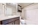 Bathroom with a combination shower-tub, vanity with dark cabinets, a decorative mirror, and modern fixtures at 3925 W 149Th Ave, Broomfield, CO 80023
