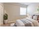 Comfortable bedroom with a bed, a plant in a white pot, and a window offering natural light at 3925 W 149Th Ave, Broomfield, CO 80023