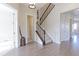 Elegant foyer with hardwood floors, staircase with rod iron spindles, and modern lighting fixtures at 3925 W 149Th Ave, Broomfield, CO 80023