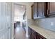 Spacious kitchen with dark wood cabinets, granite countertops, and stainless steel appliances with hardwood floors at 3925 W 149Th Ave, Broomfield, CO 80023