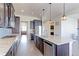 Well-equipped kitchen with a center island, granite countertops, stainless steel appliances, and dark wood cabinets at 3925 W 149Th Ave, Broomfield, CO 80023