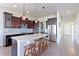 A spacious kitchen featuring dark wood cabinets, stainless steel appliances, a marble island, and hardwood floors at 3925 W 149Th Ave, Broomfield, CO 80023