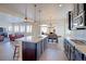 Open-concept kitchen with a large island, stainless steel appliances, dark cabinets, and seamless access to the living area at 3925 W 149Th Ave, Broomfield, CO 80023