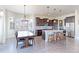 Bright, open kitchen with a marble island, stainless steel appliances, and dark wood cabinets, dining area at 3925 W 149Th Ave, Broomfield, CO 80023