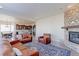 Open-concept living room with a stone fireplace, hardwood floors, and seamless access to the kitchen and dining area at 3925 W 149Th Ave, Broomfield, CO 80023