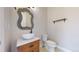 Stylish powder room with a vessel sink, decorative mirror, and modern fixtures at 3925 W 149Th Ave, Broomfield, CO 80023