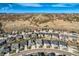 Aerial view of the residential area with many homes in close proximity with mountainous terrain in the distance at 6673 Mentha Dr, Castle Rock, CO 80108