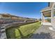 Landscaped backyard featuring terraced landscaping, a retaining wall, and a covered patio at 6673 Mentha Dr, Castle Rock, CO 80108