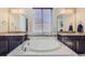 A relaxing Primary bathroom with a large soaking tub, granite counters, and dual sinks at 6673 Mentha Dr, Castle Rock, CO 80108