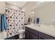 Bathroom with a single sink vanity, shower and tub combination, and decorative shower curtain at 6673 Mentha Dr, Castle Rock, CO 80108