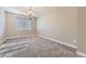 Bright, carpeted bedroom with a chandelier and a window providing natural light at 6673 Mentha Dr, Castle Rock, CO 80108