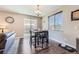 Cozy dining area with wood floors, a modern chandelier, and sliding glass doors to backyard at 6673 Mentha Dr, Castle Rock, CO 80108