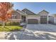 Charming two-story home with stone accents, a three-car garage, and well-maintained landscaping at 6673 Mentha Dr, Castle Rock, CO 80108