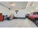 Spacious garage with ample storage, epoxy floors, and parking for multiple vehicles at 6673 Mentha Dr, Castle Rock, CO 80108