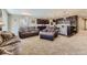 Spacious living room with combined seating area and connected kitchen with bar and appliances at 6673 Mentha Dr, Castle Rock, CO 80108