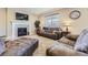 Inviting living room with plush seating, a fireplace, and large windows, offering a comfortable space at 6673 Mentha Dr, Castle Rock, CO 80108