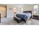 Serene main bedroom featuring a tray ceiling, plush carpeting, and a view into the ensuite bathroom at 6673 Mentha Dr, Castle Rock, CO 80108