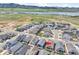 Aerial view of a residential neighborhood, highlighting a lake and the surrounding natural landscape at 11464 Stonewash St, Littleton, CO 80125