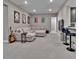 Spacious finished basement with a large sectional sofa and wet bar with seating at 11464 Stonewash St, Littleton, CO 80125