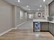 Finished basement with hardwood floors, grey cabinets and open floor plan at 11464 Stonewash St, Littleton, CO 80125