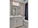 Bright bathroom features a white vanity, modern fixtures, and a stylish blue shower curtain at 11464 Stonewash St, Littleton, CO 80125