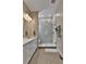 Modern bathroom with glass-enclosed shower, quartz countertop, and soft lighting at 11464 Stonewash St, Littleton, CO 80125