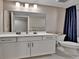 Modern bathroom with white vanity, grey floor tiles and decorative shower curtain at 11464 Stonewash St, Littleton, CO 80125