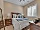 Comfortable bedroom featuring wood furniture, bright window and relaxing color palette at 11464 Stonewash St, Littleton, CO 80125
