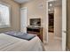 Well-lit bedroom showing a TV and walk-in closet at 11464 Stonewash St, Littleton, CO 80125