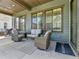 Covered patio with comfortable seating, grill, and overhead lighting at 11464 Stonewash St, Littleton, CO 80125