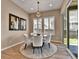 Charming dining room with a modern chandelier, neutral decor, and plenty of natural light at 11464 Stonewash St, Littleton, CO 80125
