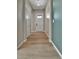 Inviting entryway with light wood-look floors and a white front door with glass panels at 11464 Stonewash St, Littleton, CO 80125
