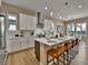 Open kitchen featuring a center island with seating, stainless appliances, and stylish pendant lights at 11464 Stonewash St, Littleton, CO 80125