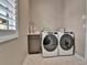Functional laundry room equipped with front-loading washer and dryer at 11464 Stonewash St, Littleton, CO 80125
