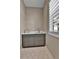 Practical laundry area with gray cabinets, sink, quartz countertop, and natural light at 11464 Stonewash St, Littleton, CO 80125