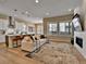 Open-concept living room featuring a modern fireplace and large windows with natural light at 11464 Stonewash St, Littleton, CO 80125
