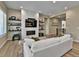Comfortable living room with built-in shelving, a modern fireplace and view of the staircase at 11464 Stonewash St, Littleton, CO 80125
