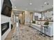 Inviting living room open to the kitchen and entryway, features a fireplace and hardwood flooring at 11464 Stonewash St, Littleton, CO 80125
