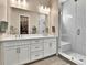 Modern bathroom featuring double vanity with large mirror and glass shower door at 11464 Stonewash St, Littleton, CO 80125