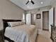 Spacious bedroom with ensuite bathroom featuring ceiling fan, neutral walls, and carpet at 11464 Stonewash St, Littleton, CO 80125