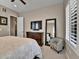 Cozy bedroom features include a television, ceiling fan, carpet, and a sitting chair at 11464 Stonewash St, Littleton, CO 80125
